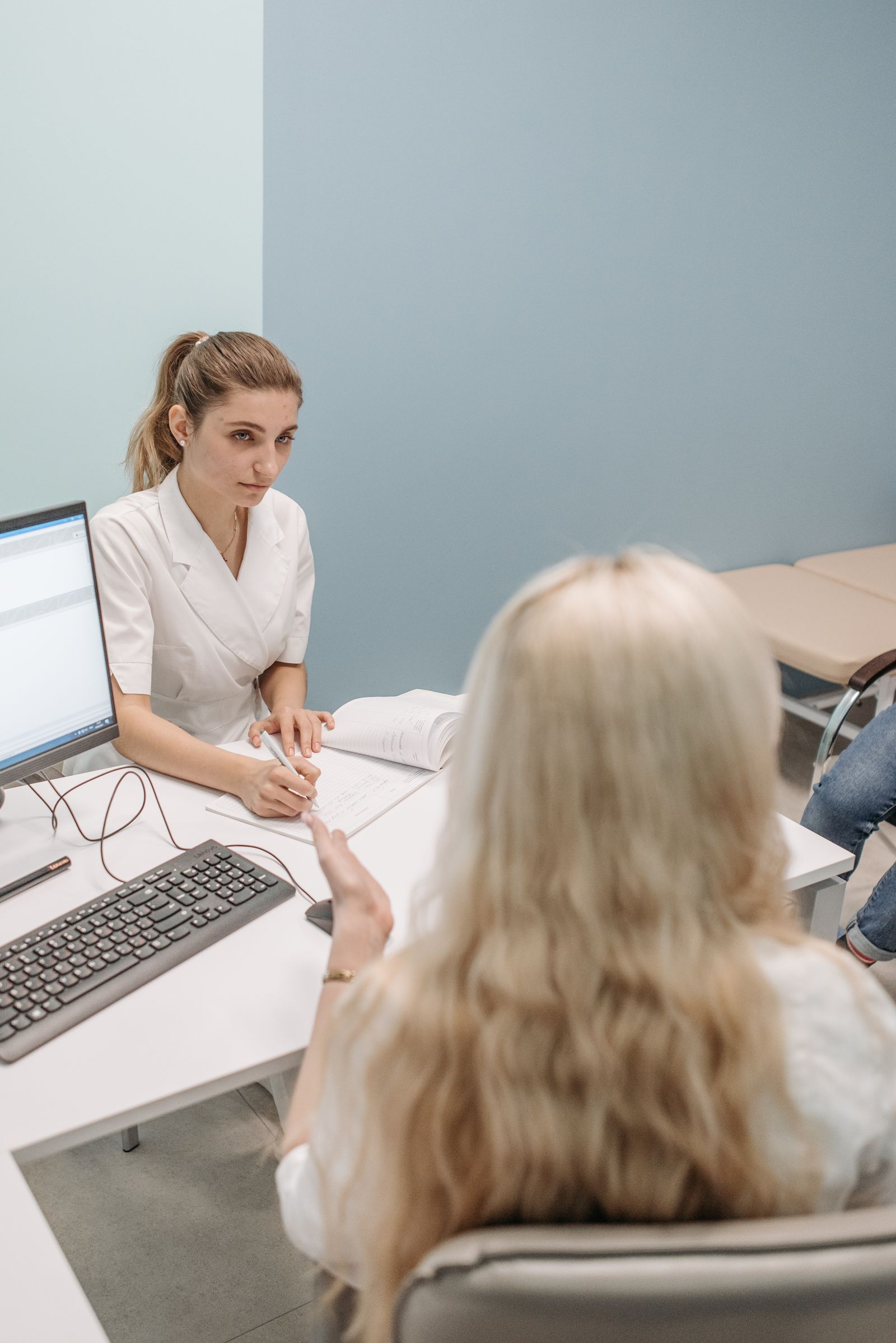 A clinician talking a patient through options in a consultation room